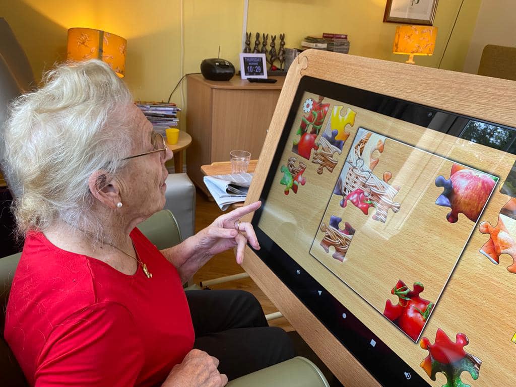 Lady playing touch screen jigsaw